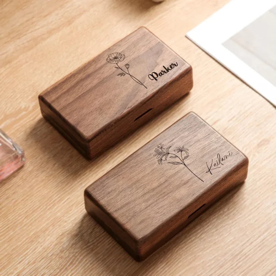 a wooden box filled with different types of jewelry